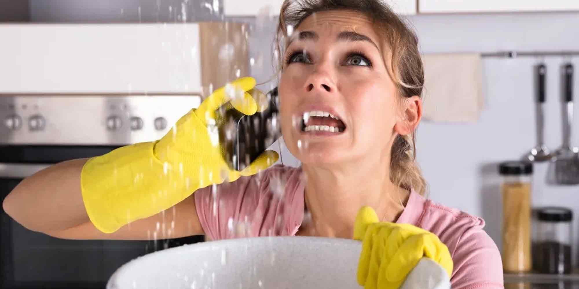 Woman Holding a Bucket Underneath a Water Leak | Professional Taylorsville Plumbing Services | Plumber in Taylorsville Utah