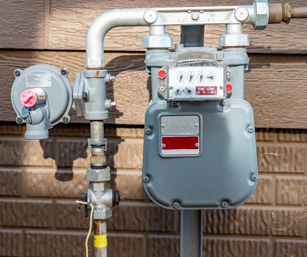 Gas Meter Next to House | Monkey Wrench Plumbing, Sewer & Drain | Gas Line Services & Repair | Natural Gas Plumbers in Utah