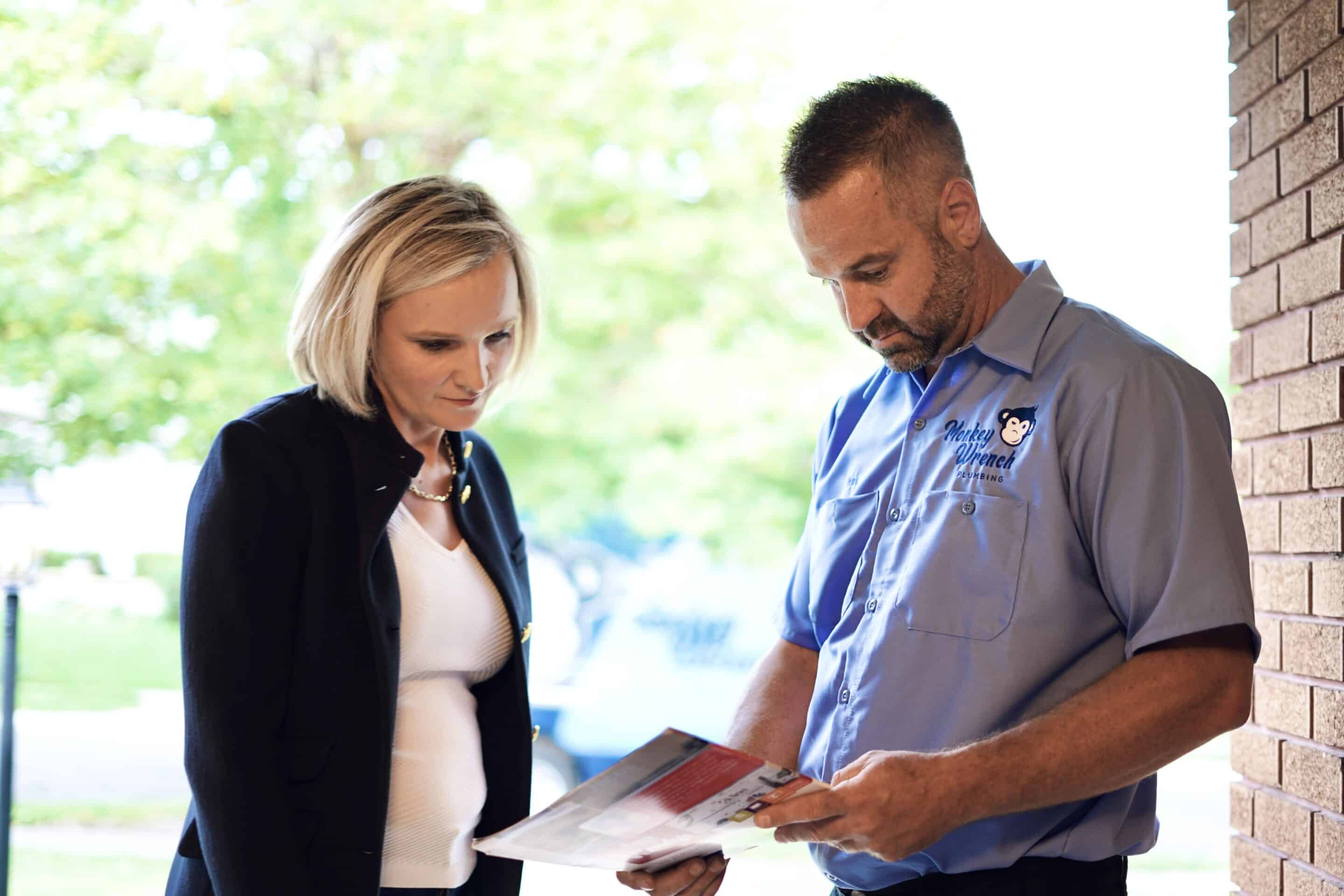 Plumber Explaining a Pamphlet to a Client | Monkey Wrench Plumbing | Professional Plumbing Repair in West Jordan