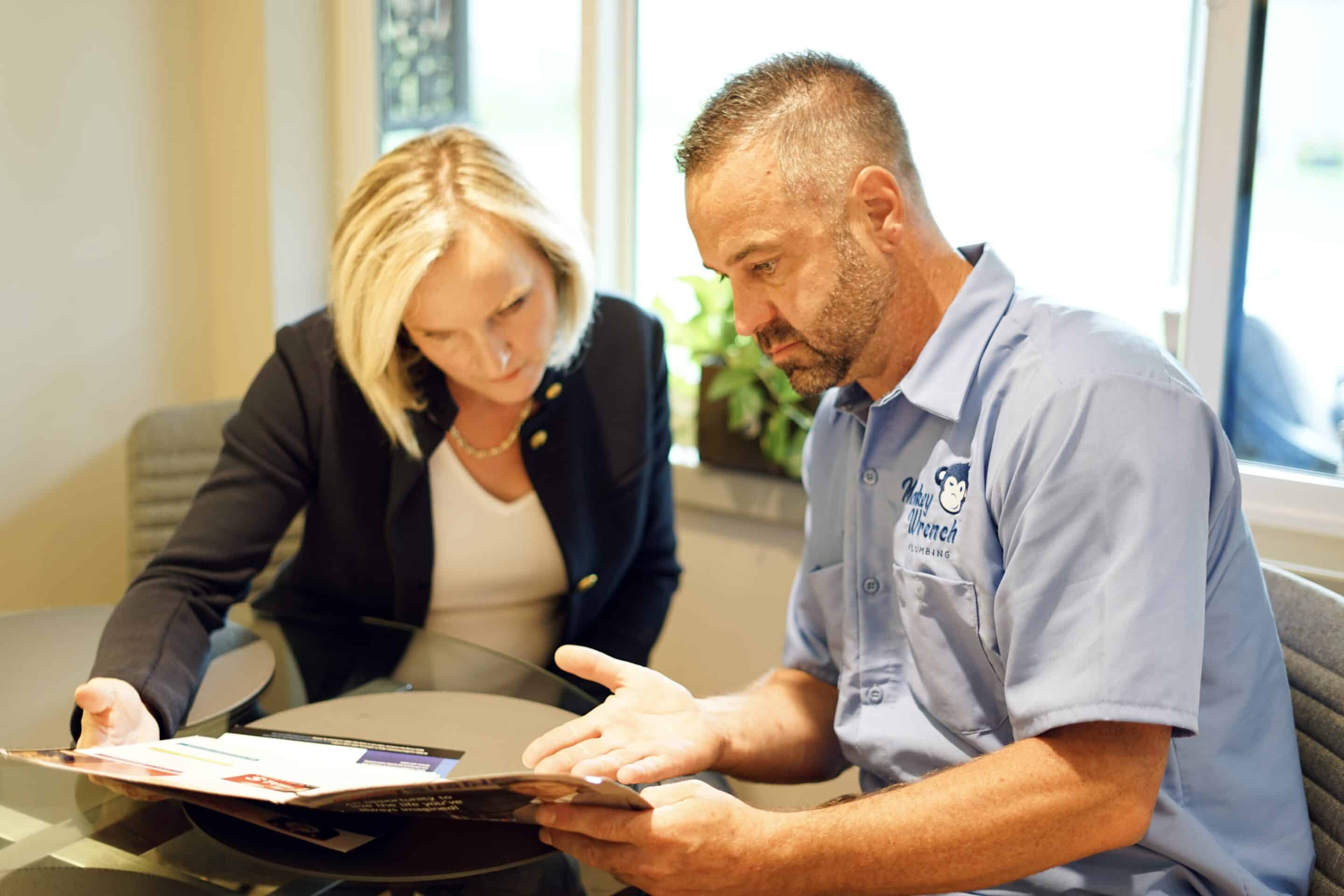 Monkey Wrench Technician with a Pamphlet | Expert Orem Plumbers | Professional Drain Cleaning in Orem