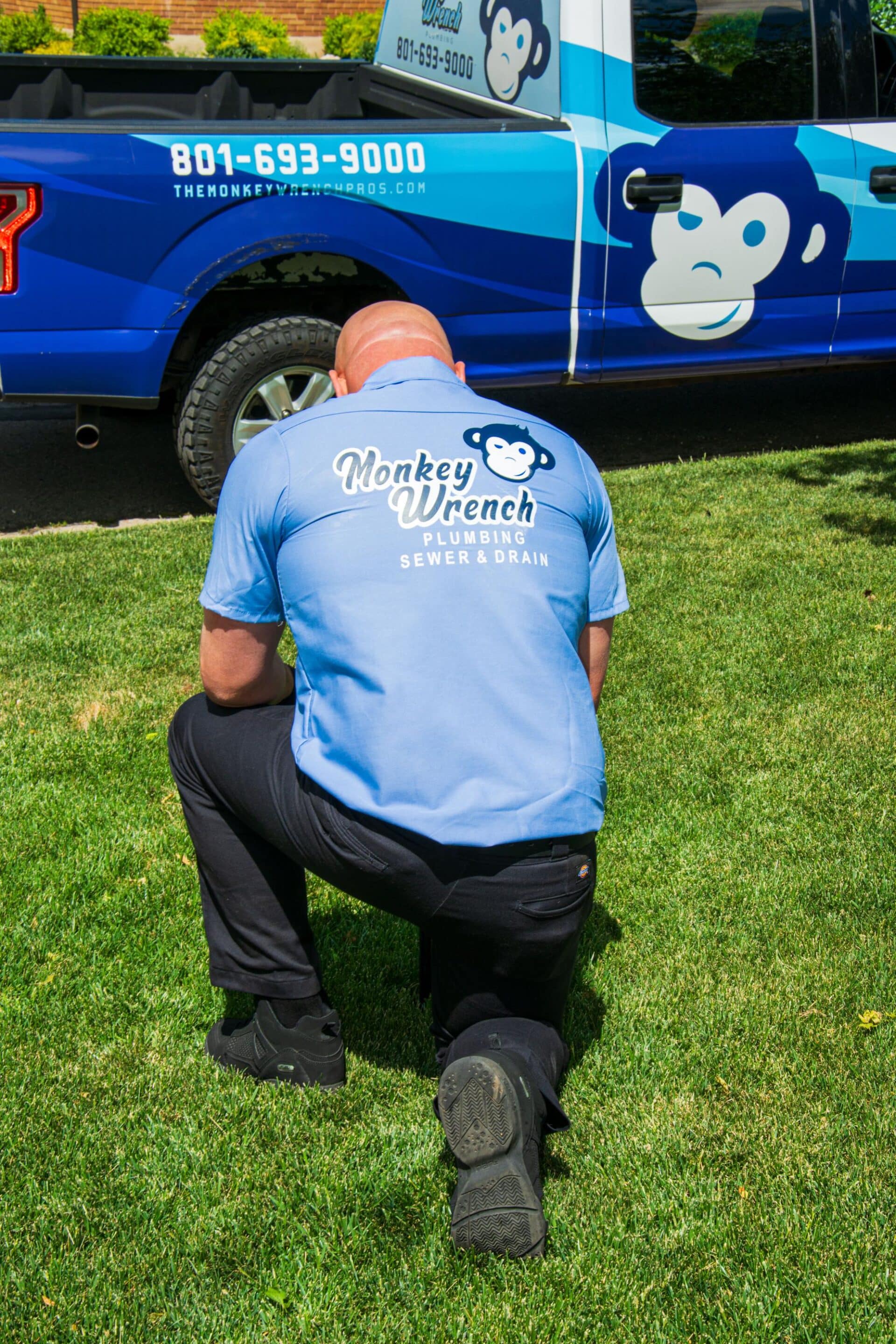 Sprinkler repair technician checking irrigation lines for a Utah home